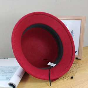 Detail view of red wool blend hat interior with mesh veil and black sweatband