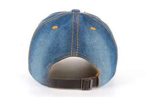 Detail of blue denim baseball hat back with orange stitching and leather strap