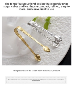 Close-up of gold and silver stainless steel sugar tongs with rose relief patterns