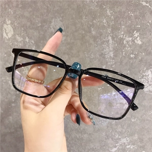 Close-up of black square eyeglass frame with printed size 1846 55☐17-148 on the temple