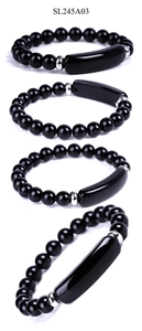Detailed macro view of 8mm polished black onyx stone beads with stainless steel accents