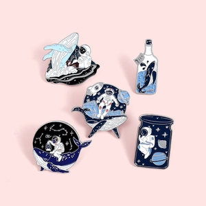 Five pieces enamel astronaut and whale pins set with blue ocean surrealist designs