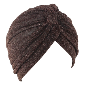 Close-up of bronze ethnic turban hat showing metallic fiber texture and pleated details