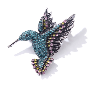 Macro detail of vintage silver hummingbird brooch with vibrant multicolor rhinestones