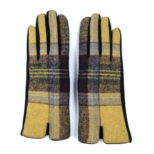 Close-up of winter wool blend gloves with yellow and brown tartan plaid pattern