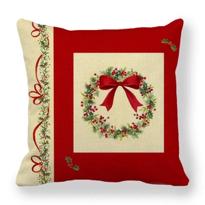 Detail of red linen Christmas pillowcase featuring festive wreath pattern and bow
