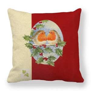 Detail of Christmas linen pillowcase featuring vintage robin illustration on holly branch