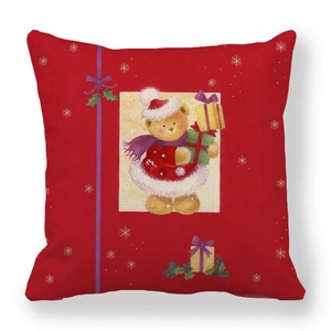 Detail of red linen Christmas pillow cover featuring a festive bear and gift box design