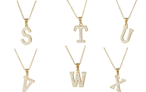 Detailed close-up of 18k gold plated letter pendants S to X with sparkling pavé zircons
