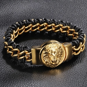 Men's gold lion head bracelet featuring black braided leather on a textured background