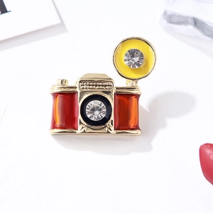 Vintage red enamel camera brooch with gold alloy frame and crystal lens accents