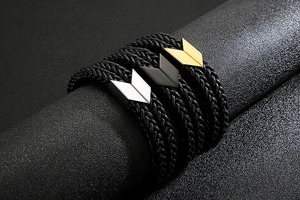 Detail of double-layer braided leather bracelets with stainless steel arrow magnetic clasps
