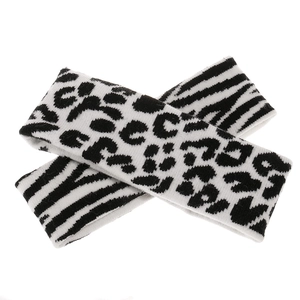 Detail of winter knitted headbands featuring black and white leopard and zebra patterns