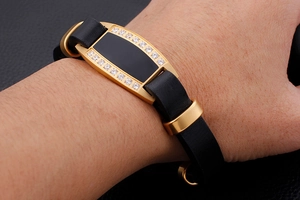 Close-up of men's gold stainless steel leather bracelet with cubic zirconia inlay details