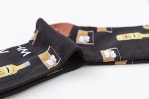 Detailed close-up of cotton socks featuring beer bottle and wine glass embroidery
