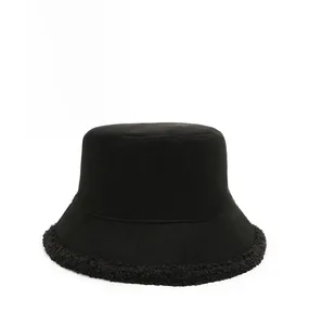 Detailed shot of black bucket hat featuring thick canvas fabric and warm plush fleece brim