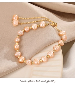 Detail of 14K gold plated baroque pearl bracelet with adjustable drawstring chain