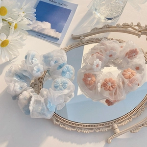 Floral embroidery organza scrunchies in sky blue and orange set on mirror