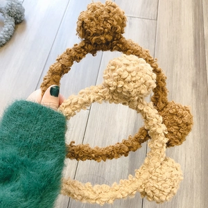 Detailed shot of cute fluffy lamb wool bear ear hair hoop, soft plush winter headband.