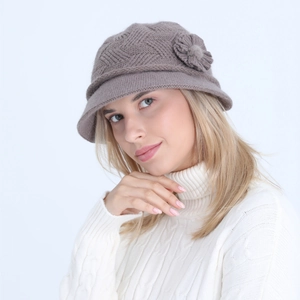 Close-up detail of brown winter knitted bucket hat with elegant side flower decoration