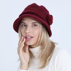 Detail of burgundy knitted hat featuring elegant floral accents and textured weave