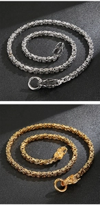 Detail of silver and gold dragon head clasps on heavy box chain rocker necklaces