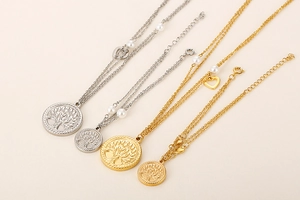 Detail view of double-layer necklaces with Tree of Life and heart charms and pearls