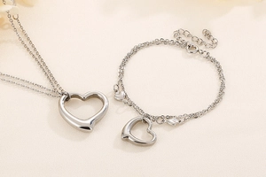 Detailed macro view of silver double-layer heart necklace and bracelet jewelry set