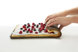 Brown silicone baking mat for Swiss rolls with fresh berries and cream filling