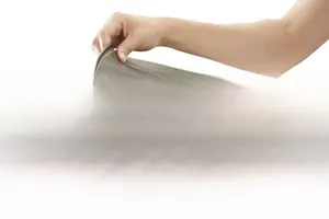 Macro view of flexible brown silicone baking mat used for rolling a cream fruit cake roll