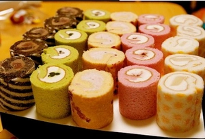 Detailed close-up of Swiss rolls on a silicone baking mat with creamy texture