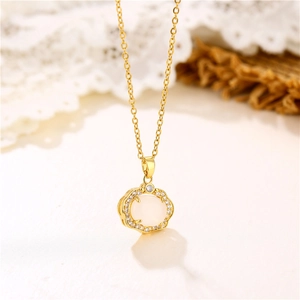 Elegant gold necklace featuring a white faux jade oval pendant with zircon accents