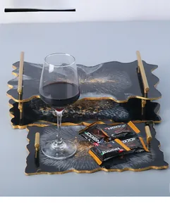 Detailed view of handmade resin tray set with gold leaf and metallic handles