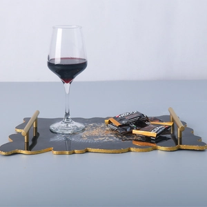 Black resin serving tray with gold foil flakes and metal handles for home decor