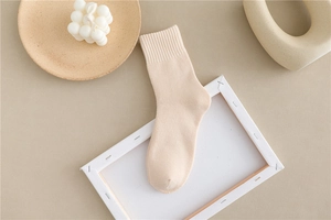 Detailed view of cream thick cotton thermal socks with elastic ribbed cuffs and soft texture
