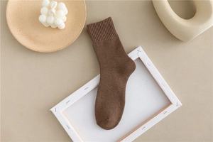 Close-up of thick thermal cotton socks in dark brown with ribbed cuffs and cozy texture