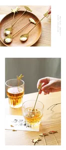 Detailed view of golden cartoon cat coffee spoon stirring drink in a glass cup