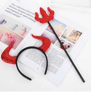 Detail of red sequined devil horn headband and matching trident for Halloween party costume