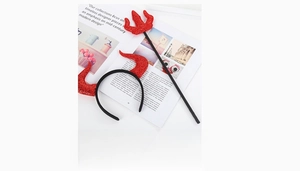 Detail view of red glitter devil horns headband and trident set for Halloween costume