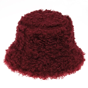 Detail of burgundy faux sheepskin texture on a winter bucket hat with fluffy teddy fleece