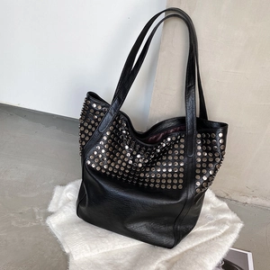 Large black leather tote bag with silver studs and long shoulder straps for women