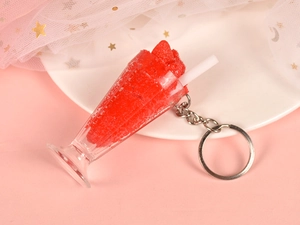 Detailed view of red simulation ice cream sundae keychain on pink starry mesh background