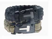 Detail of survival paracord bracelet with integrated whistle and flint fire starter buckle