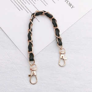 Close-up of black leather and gold metal chain strap with sturdy lobster clasps