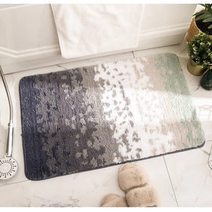 Detail of gradient blue and green flocked bathroom rug with absorbent plush texture