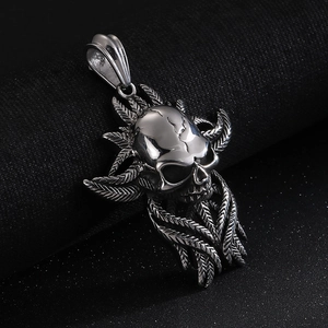 Detailed macro shot of a punk skull pendant with intricate wing textures in silver steel