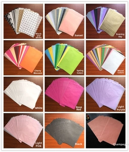 Macro view of A5 tissue paper assortment in various colors and dotted patterns for DIY