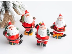 Close-up of four red and white resin Christmas Santa Claus figurines for holiday decor
