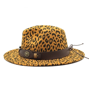 Detail of leopard print fedora featuring a brown leather band and bull head emblem