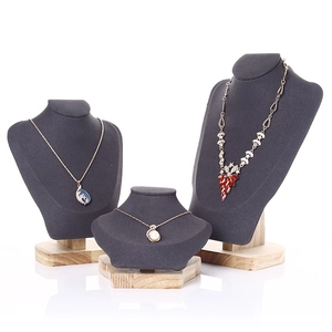 Three-piece dark grey velvet necklace bust display set with solid wooden bases for jewelry